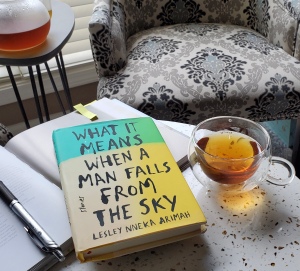 What it Means When A Man Falls from the Sky book beside a cup of tea 